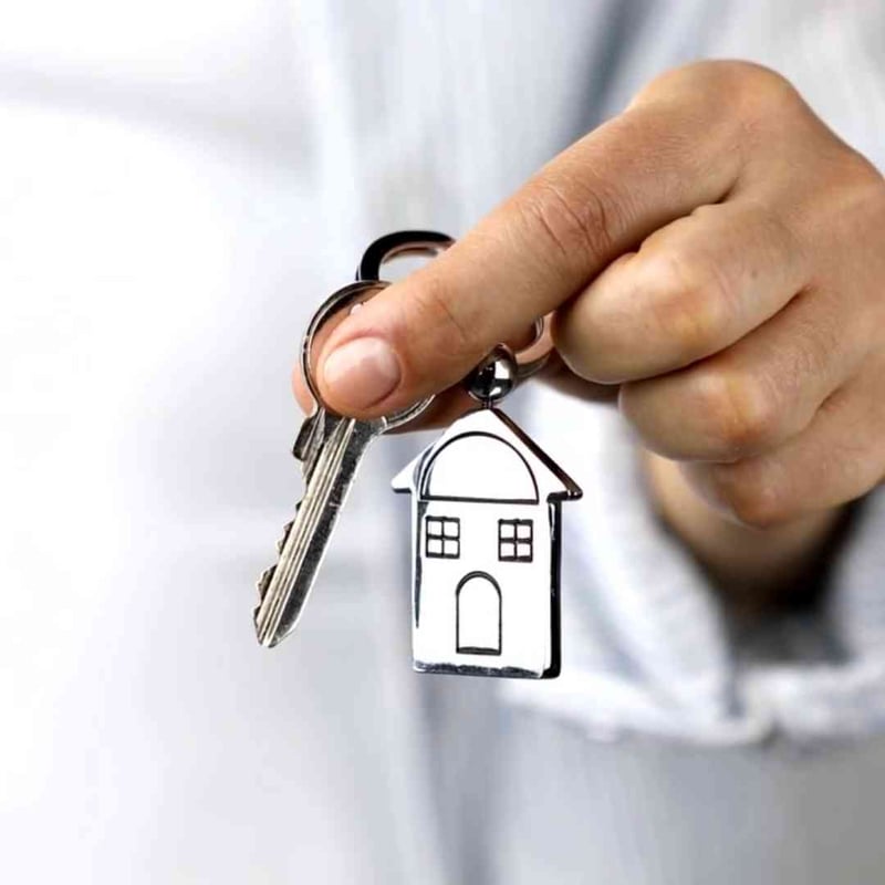 Hand holding house keys, representing a jumbo home loan from TAG Lending Group